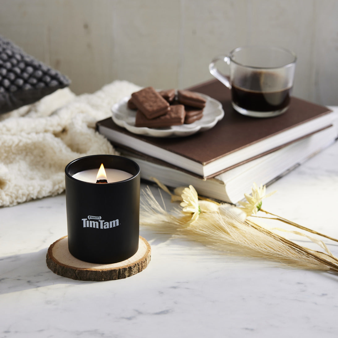 Tim Tam Candle, pictured with biscuits and black coffee